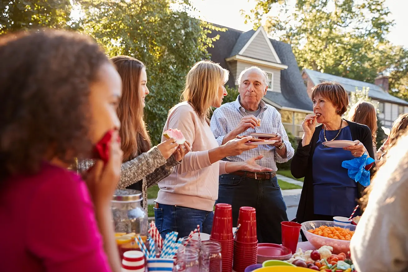 Extended family eating at outdoor reunion party