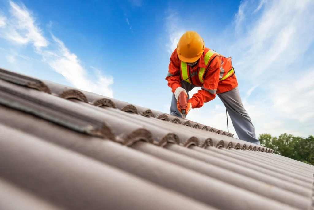 professional worker repairing the roof wearing safety gear