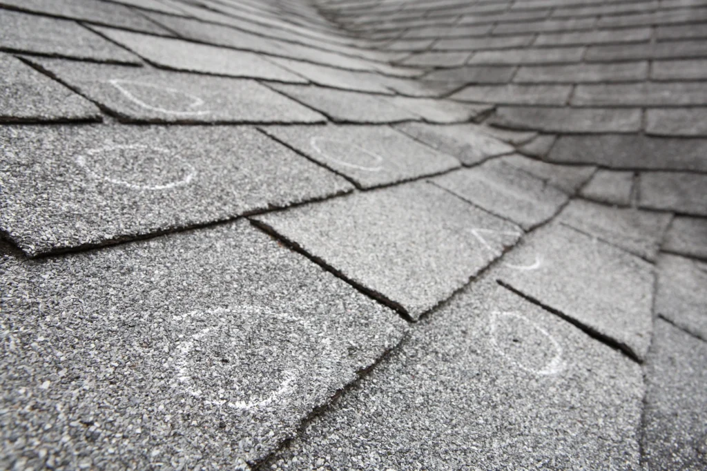 close up of impact resistant shingles damaged by hail