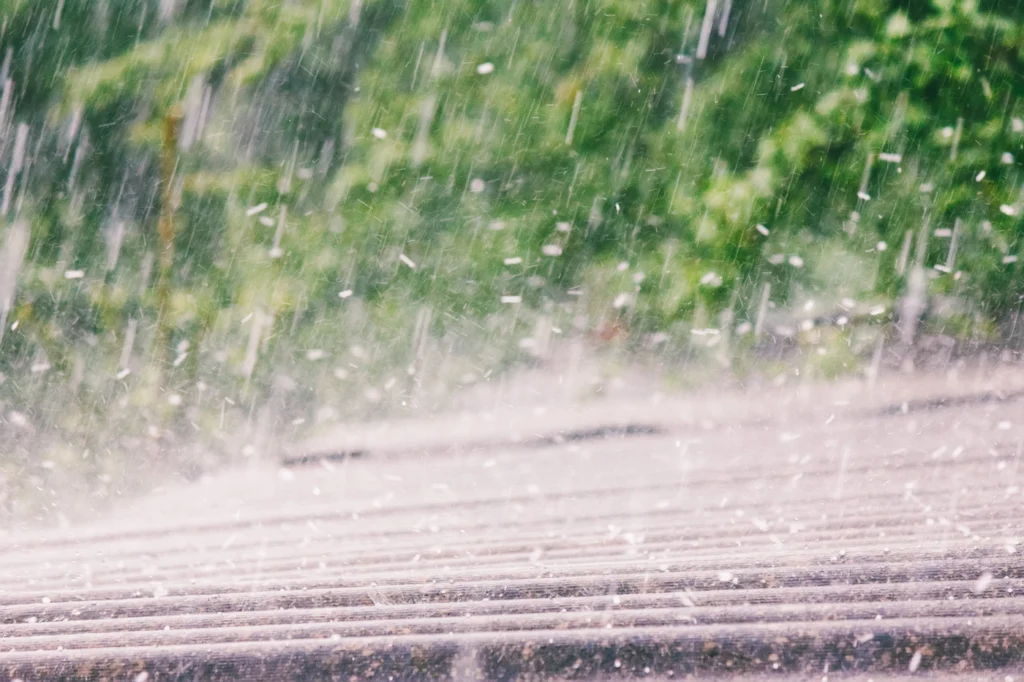 close up of hail storm damage on metal roofing system in oklahoma
