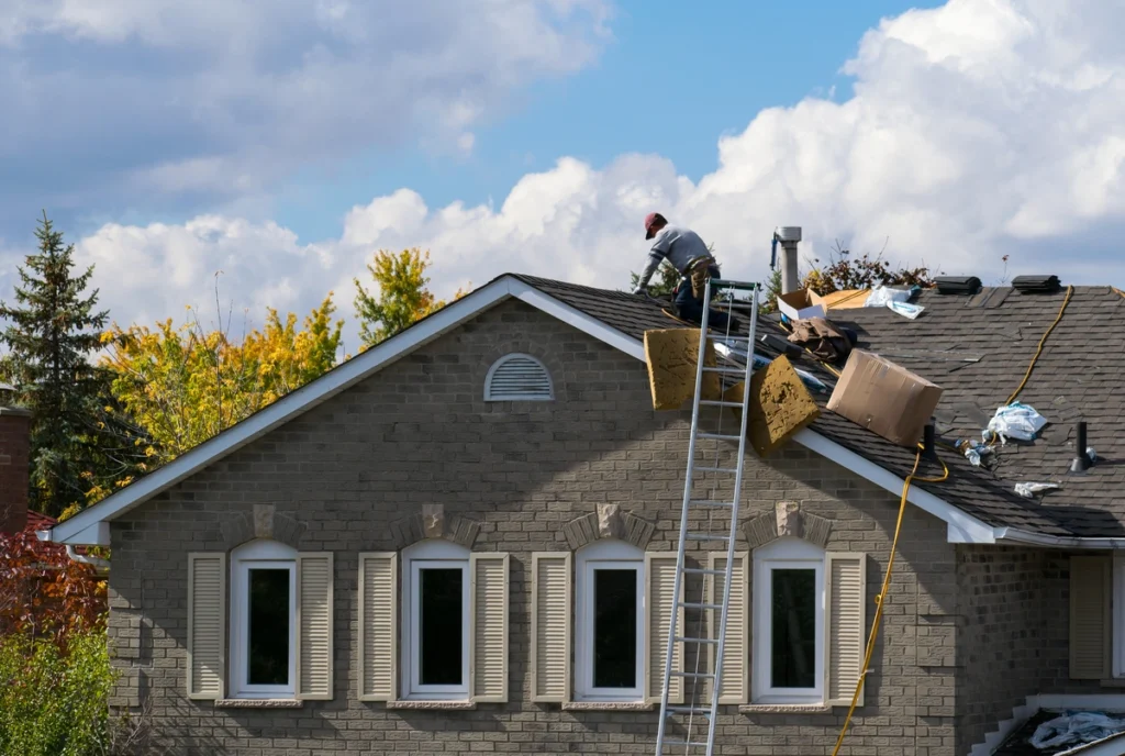 construction workers on the house roof repairing