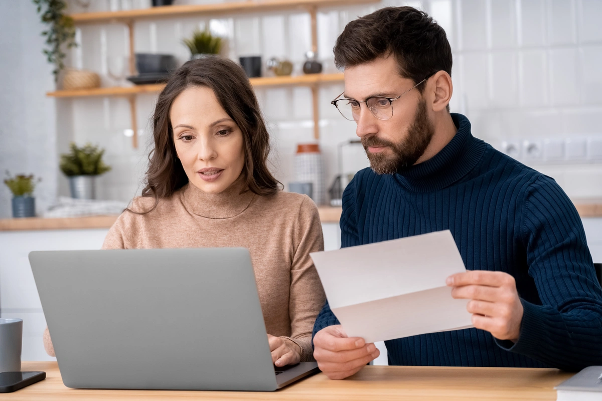 young couple calculating cost-shingles roof cost