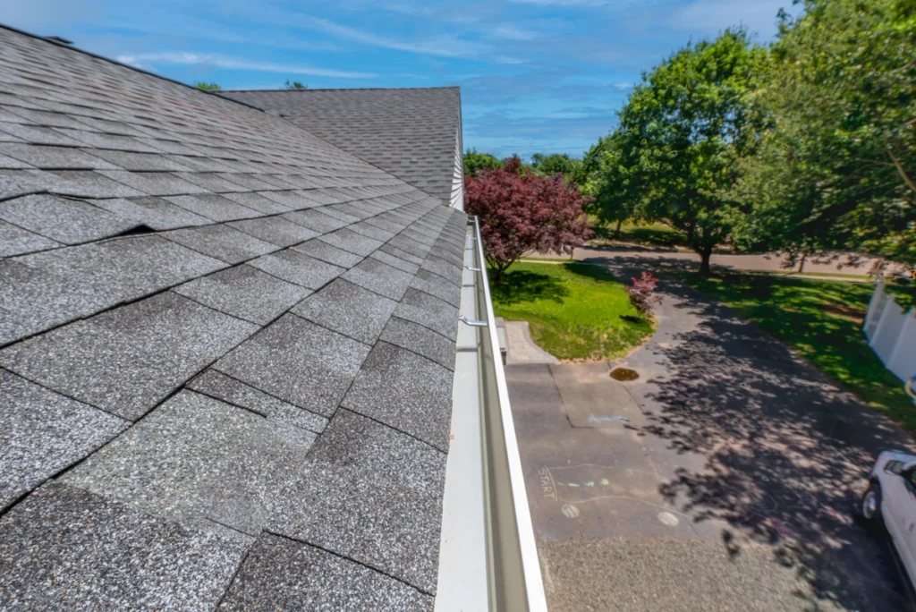 Side view of newly cleaned roof and gutters on home-gutter and roof cleaning