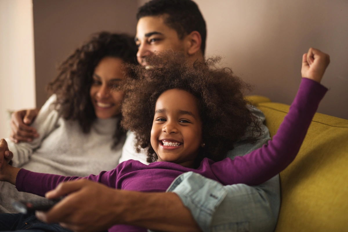 Young happy homeowners enjoy new home with their kids after new roof installation
