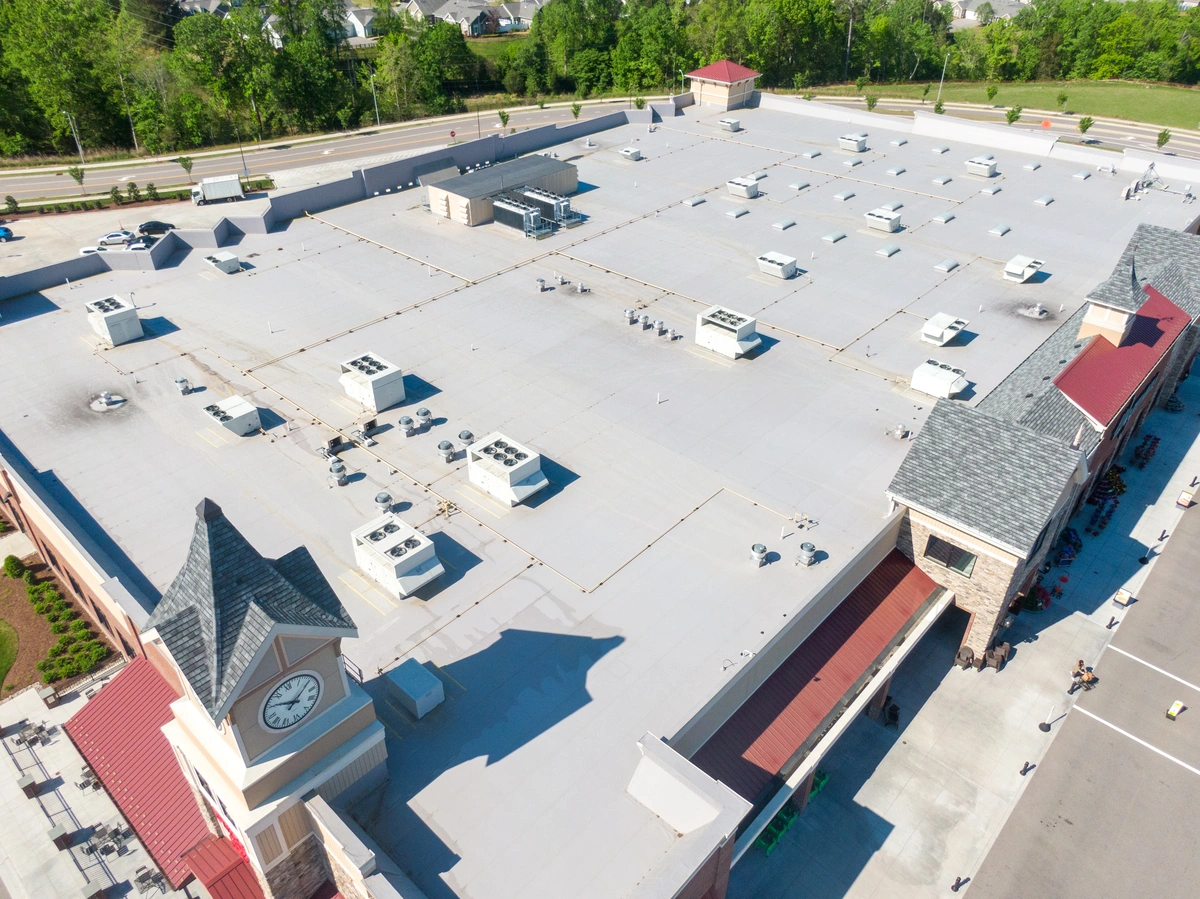 aerial view of flat roofing system installed with white tpo materials