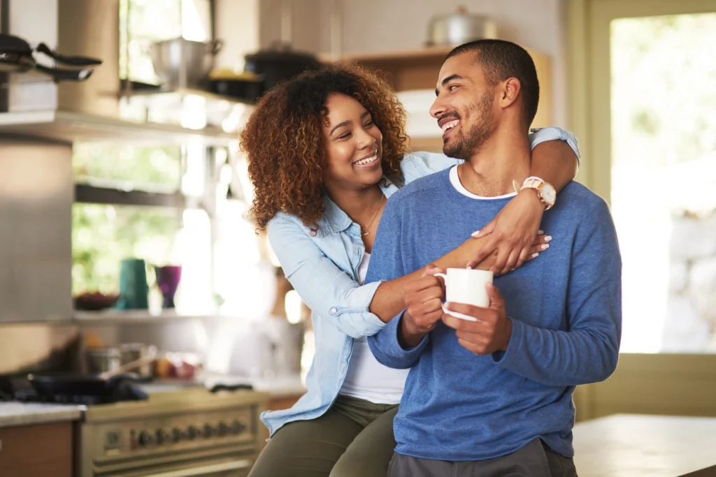 Happy young couple enjoy home after roof repairs in Yukon ok