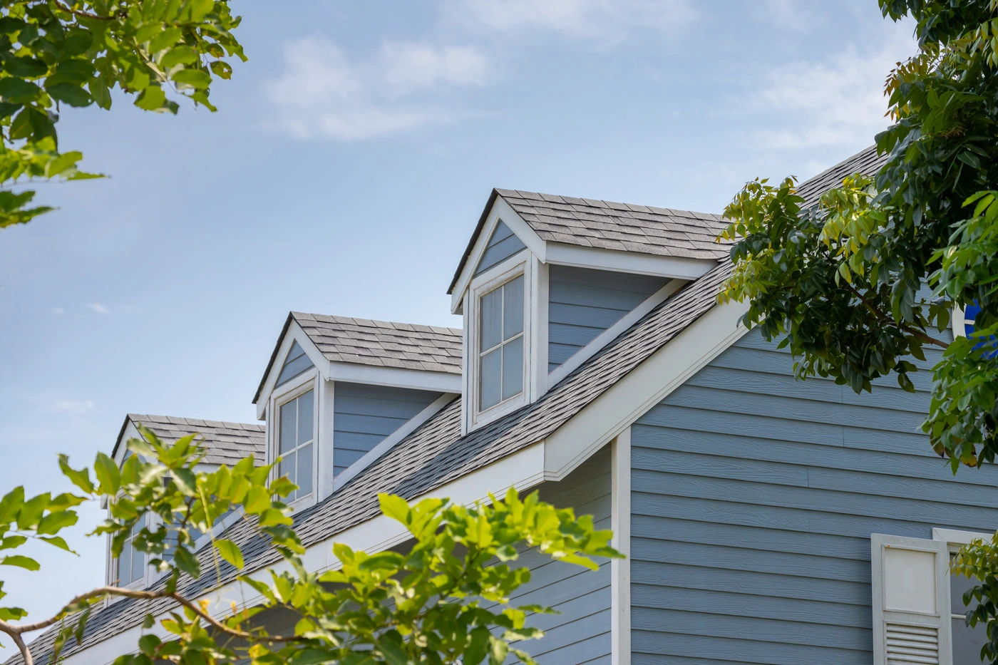 storm damage roof repair - shingle roof on blue house in Yukon OK