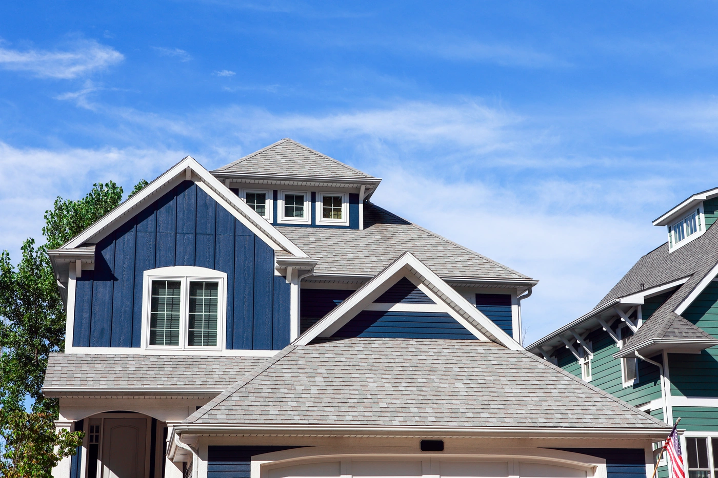 Residential home in Mustank OK with blue siding and roof replacement after storm damage