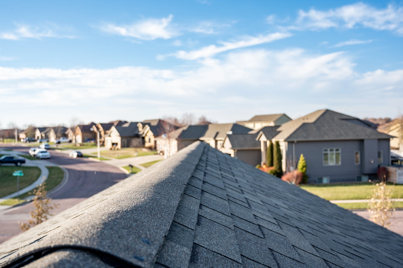 Close up view of shingle roof ridge - new shingles installed after roof storm damage