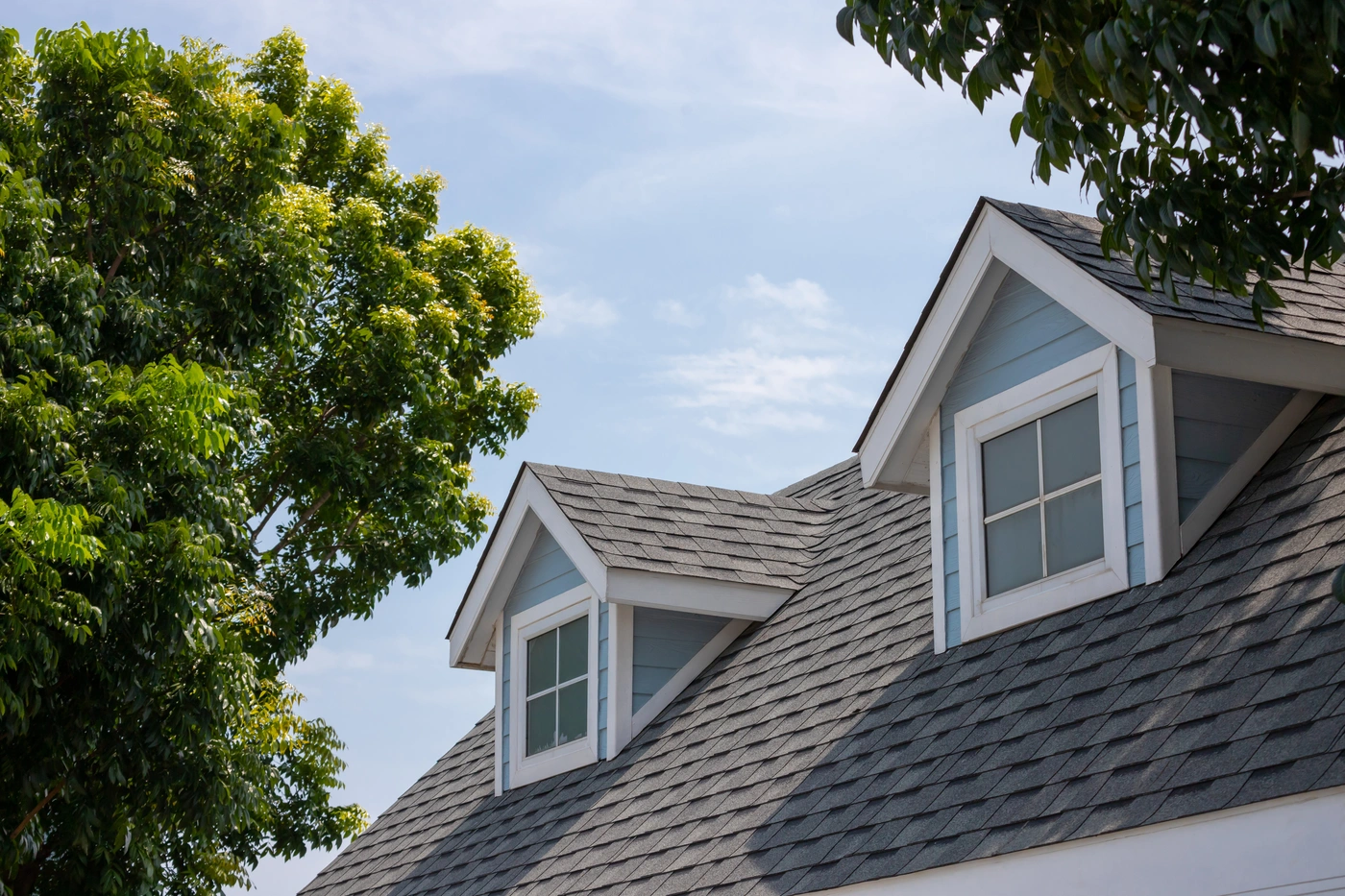 New roof installation - light grey shingles installed after storm damage
