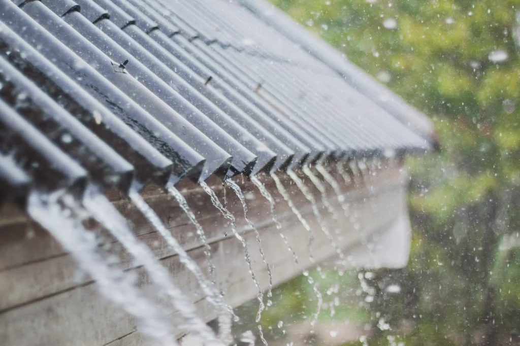 close up of corrugated metal roofing system with sloped gable roof and eaves