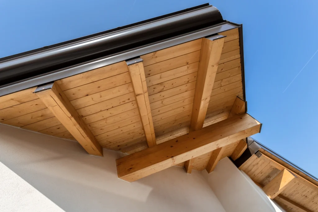 close up of underside of open roof eaves with wood framing