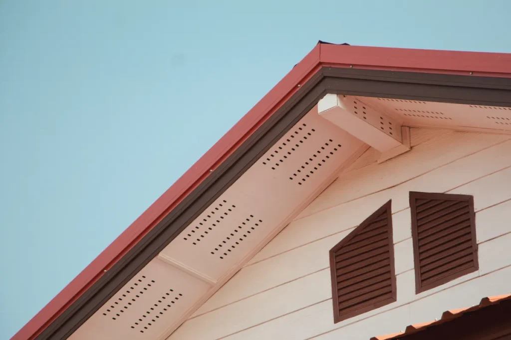 red roof eave with soffit vents and gable vent