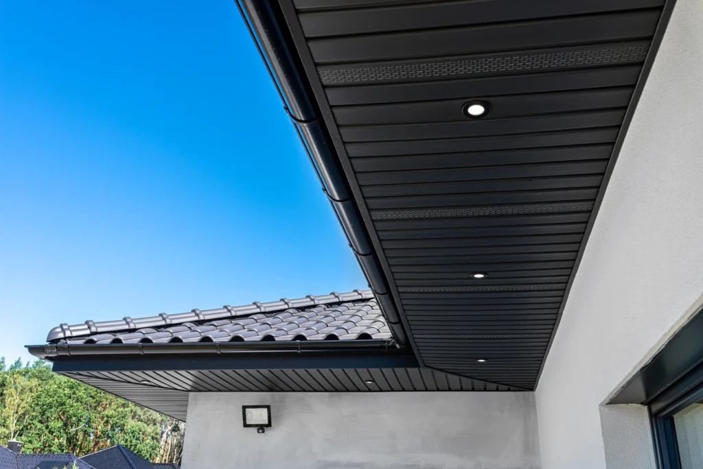 close up of underside of closed roof eaves and black vinyl roof soffits
