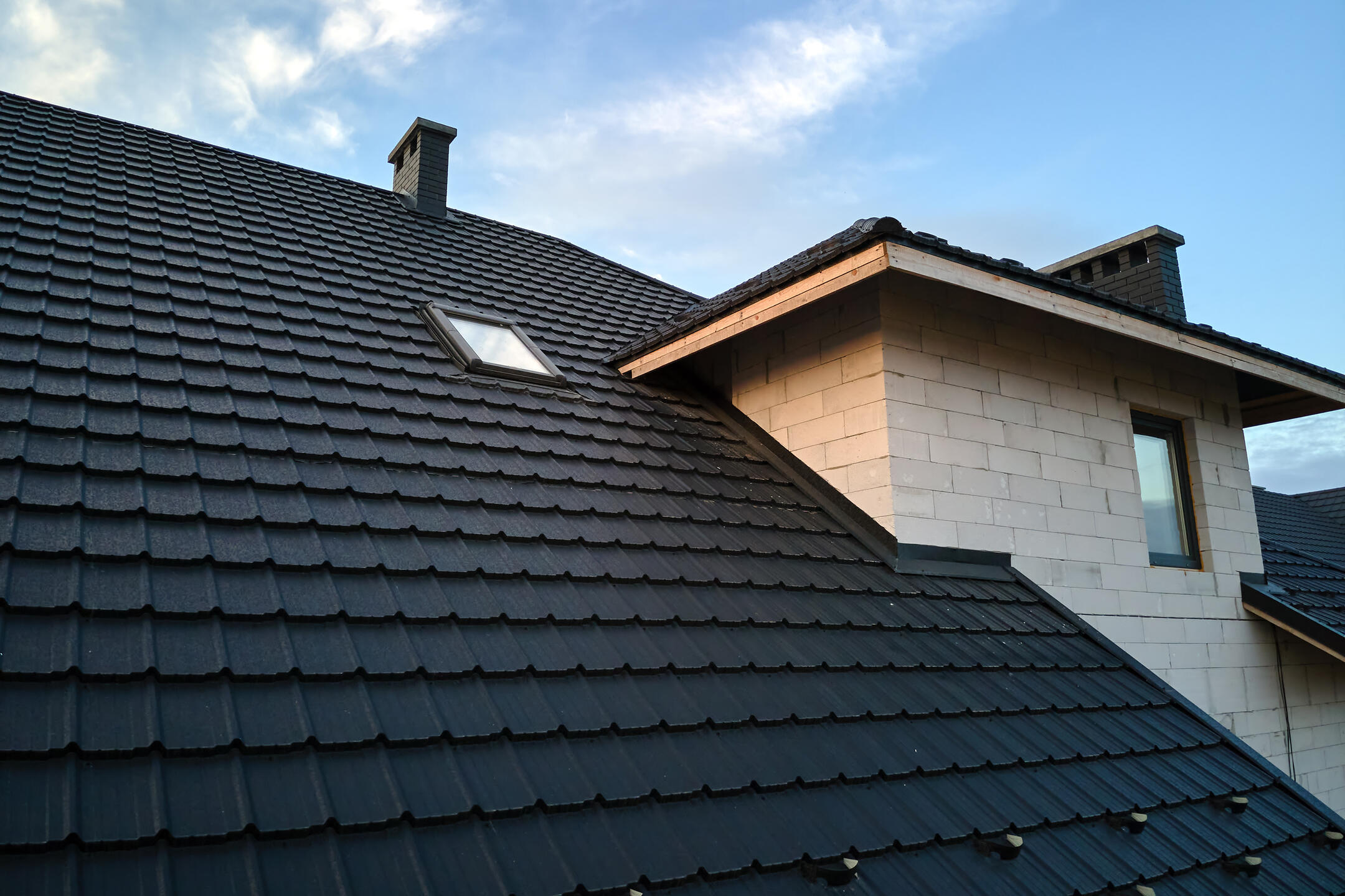 black roof shingles-close up of a house with black ceramic tile shingle roof