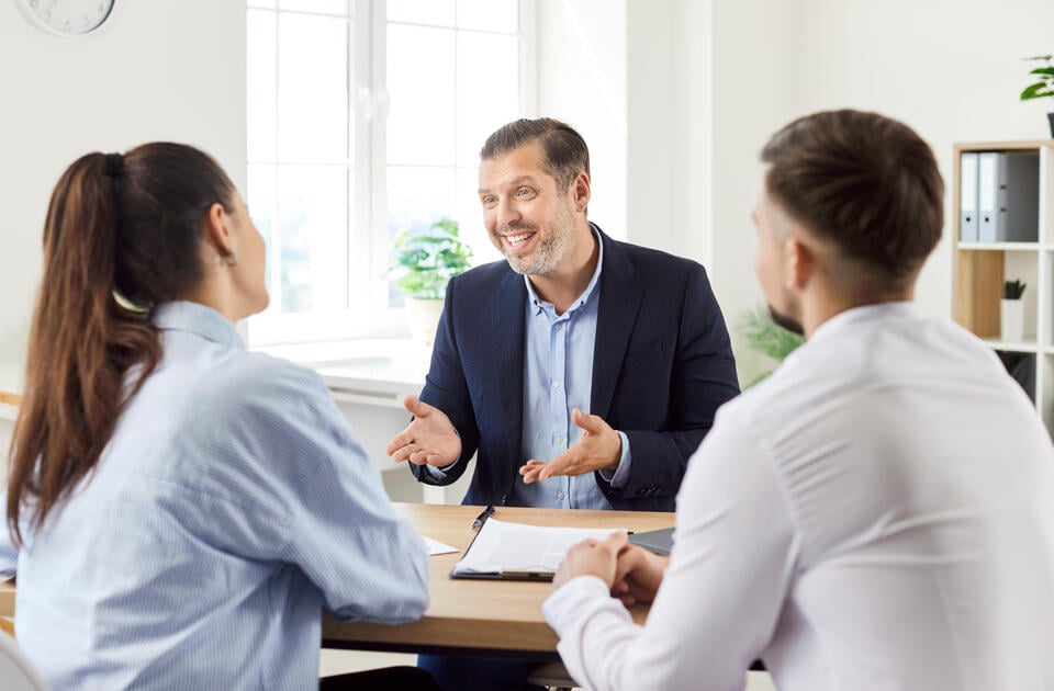 roof financing-couple discussing roof financing with a banker