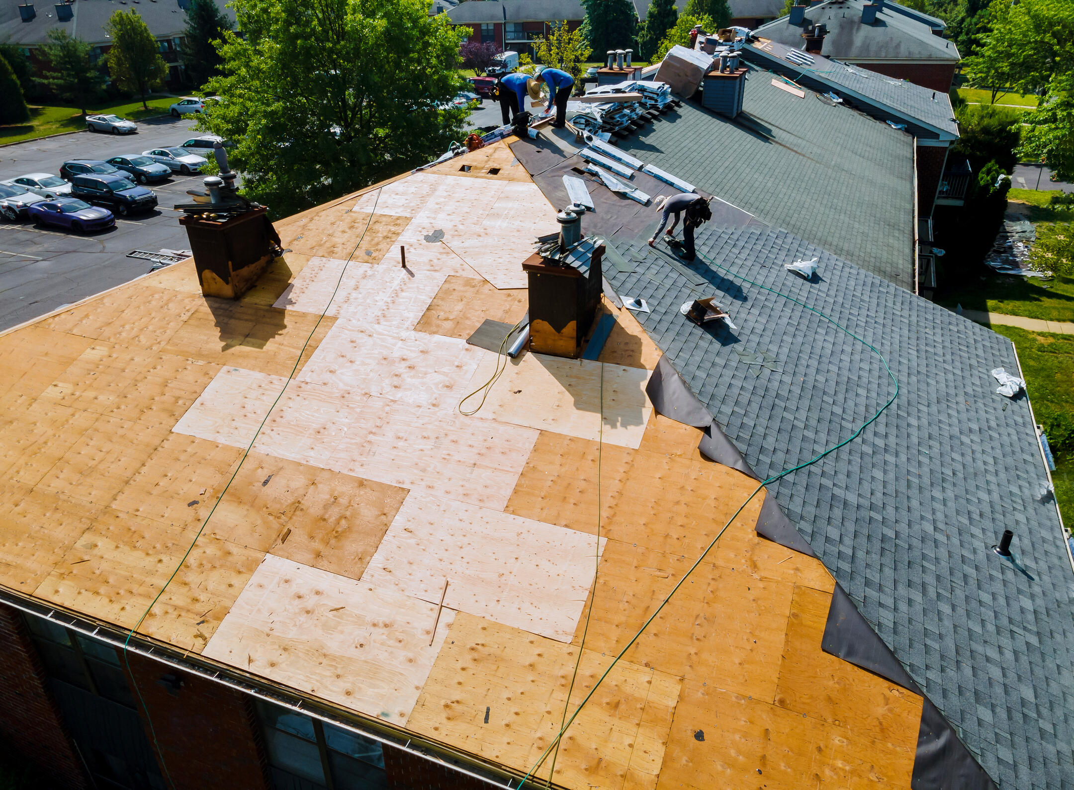 roof warranty-aerial view of a roofing crew replacing a shingle roof