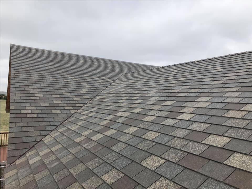 f wave shingles cost-close up of gray multi colored shingles on house roof