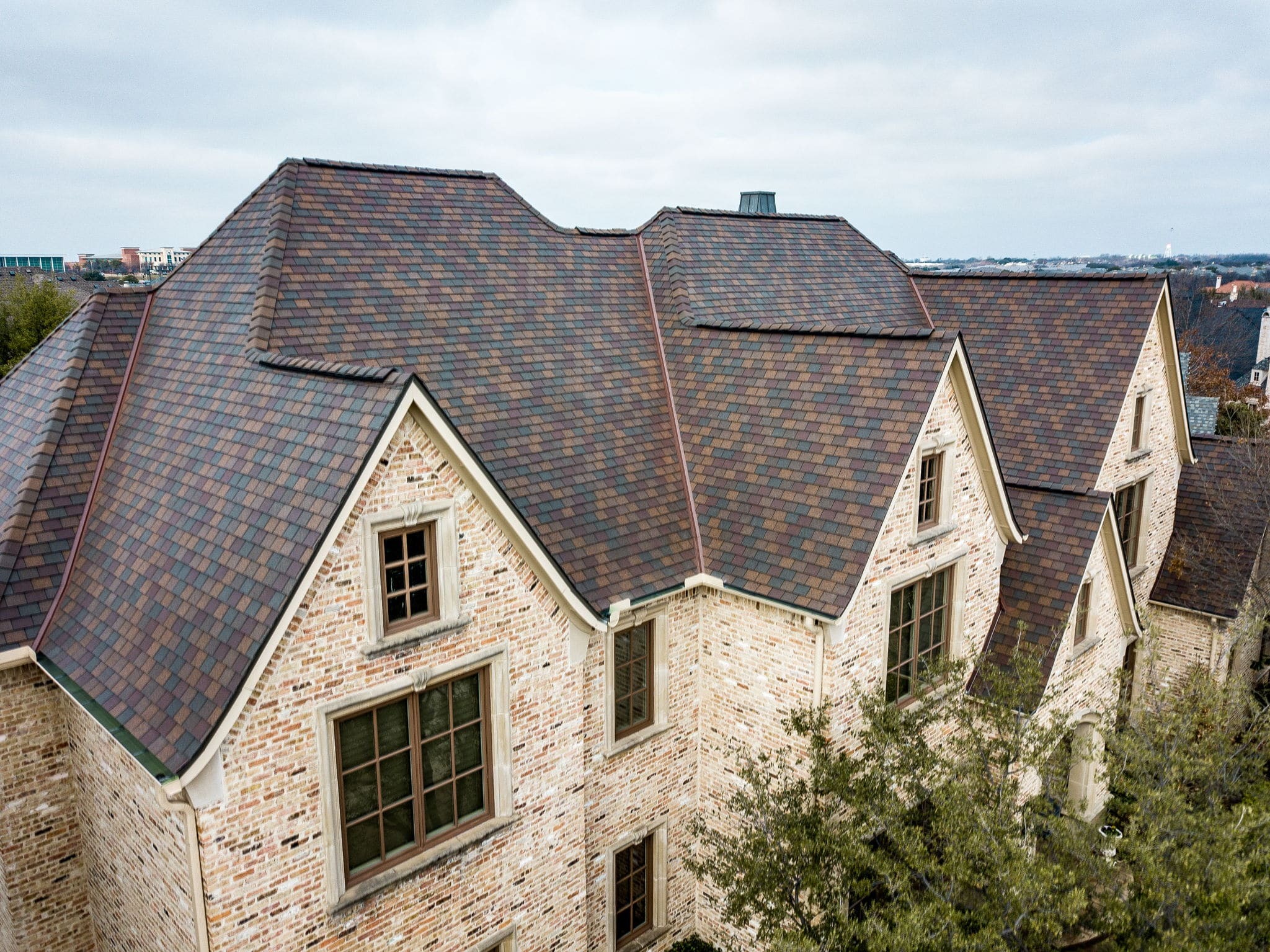 f wave shingles cost-multi colored brown shingles on light brick house