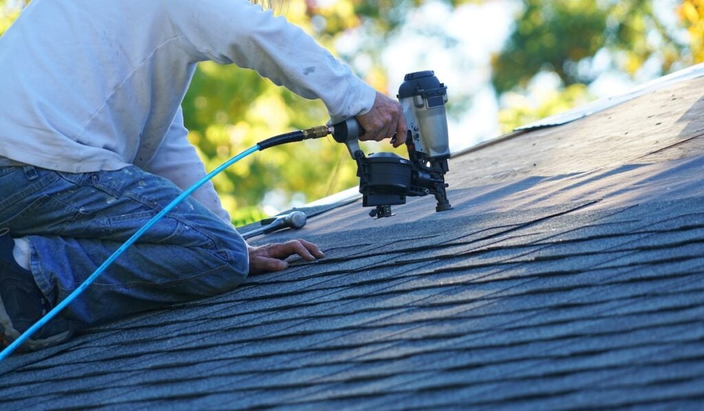 person installing asphalt shingles shingle calculation