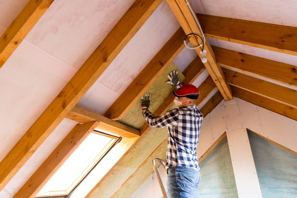 man installing thermal roof insulation
