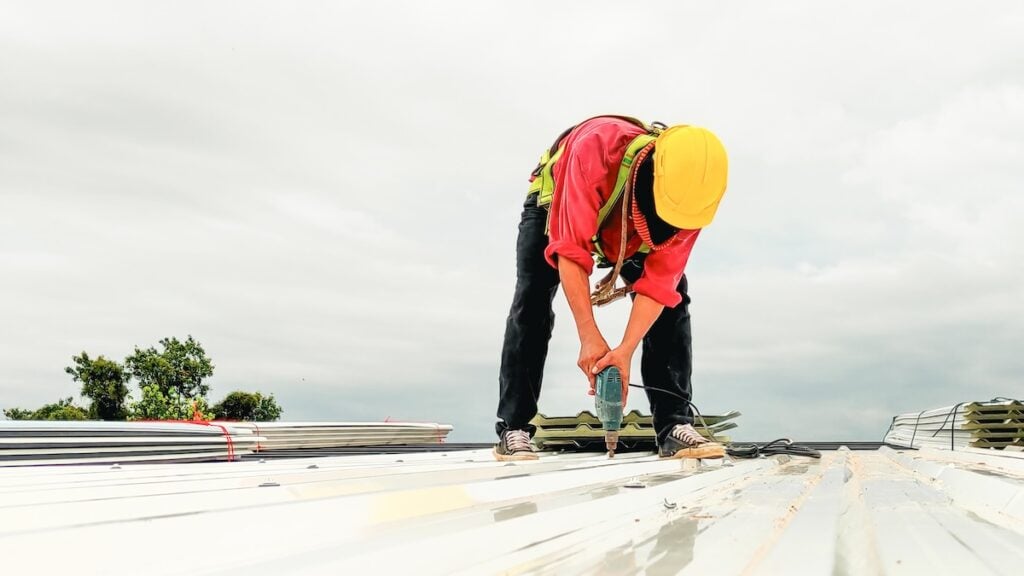 roofer installing metal commerical roof
