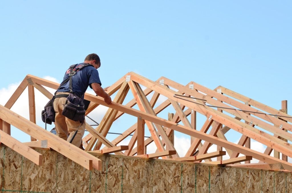 roofer installing roof truss