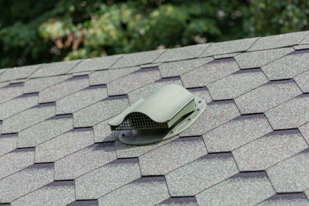 Close-up of ventilation in the sloped roof of house. Construction of houses. Attic ventilation