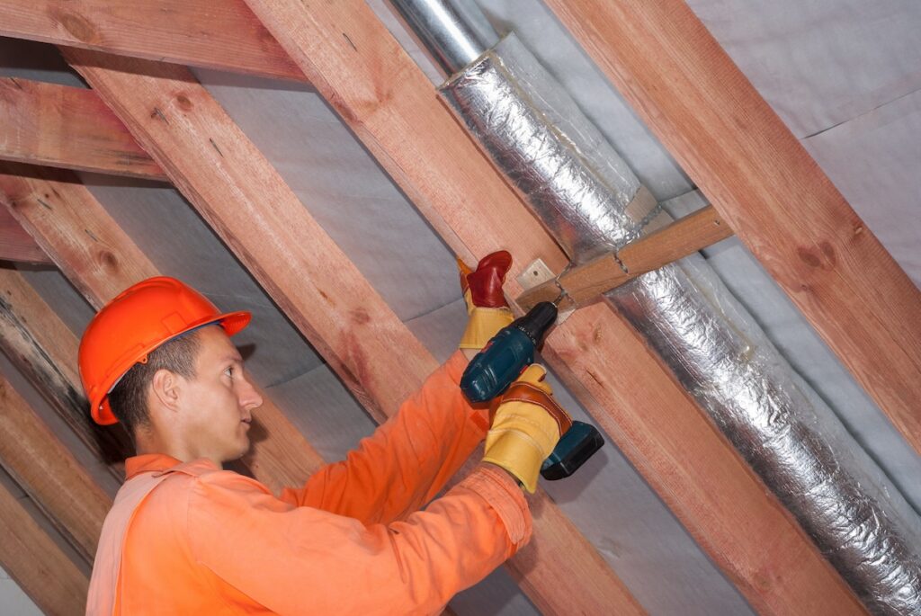 installer wraps the air duct with mineral wool and foil
