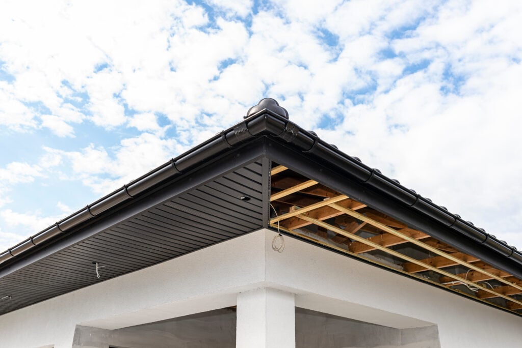 Scaffolding with three rows of wooden battens and a modern graphite soffit vents made in half, visible H and J slats.