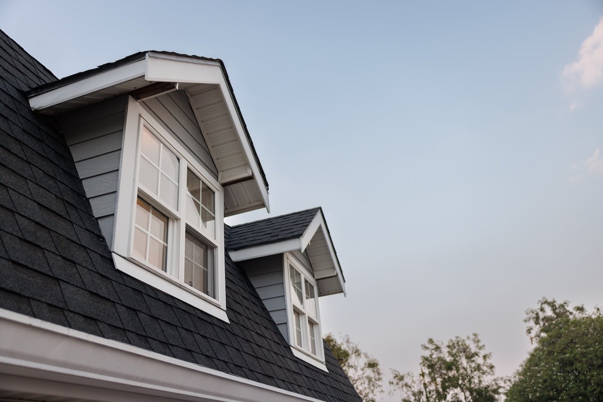 garret house with roof shingle in the evening time. wooden garret house and shingle tiles in the morning.