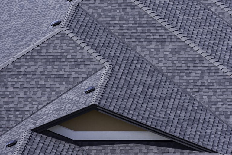Rooftop in a newly constructed subdivision in Kelowna British Columbia Canada showing asphalt shingles and multiple roof lines