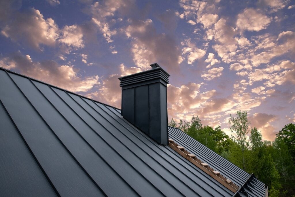 cost of metal roof vs shingle Modern metal chimney on the roof for ventilation