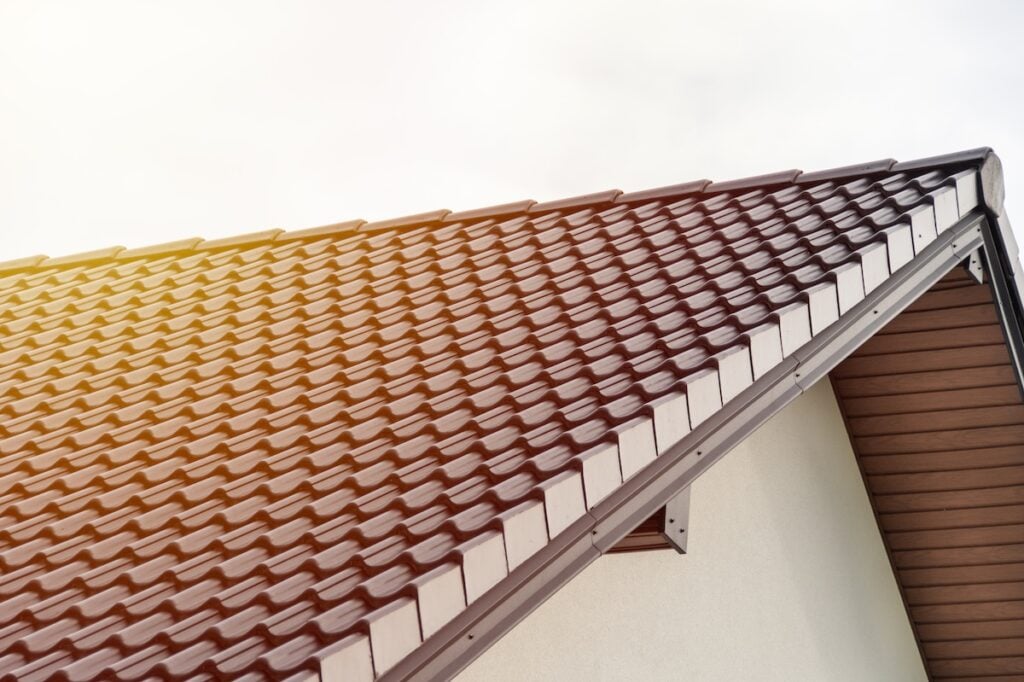 A close-up view of a contemporary roof design featuring geometric shingles. The warm tones reflect natural light, enhancing the architectural aesthetic for construction and design applications.