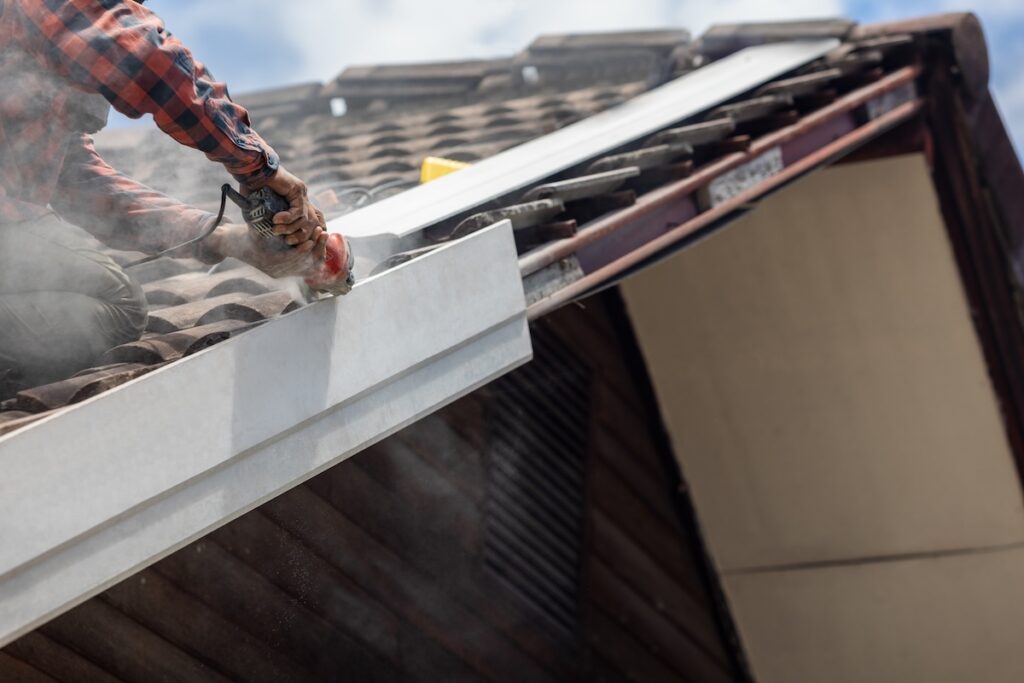 Handyman replace roof eaves with artificial wood.
