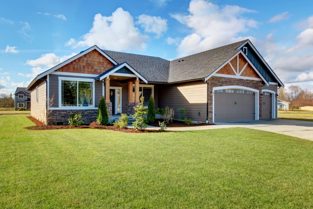 how much does a new roof cost Large modern house with walkway and lots of grass.
