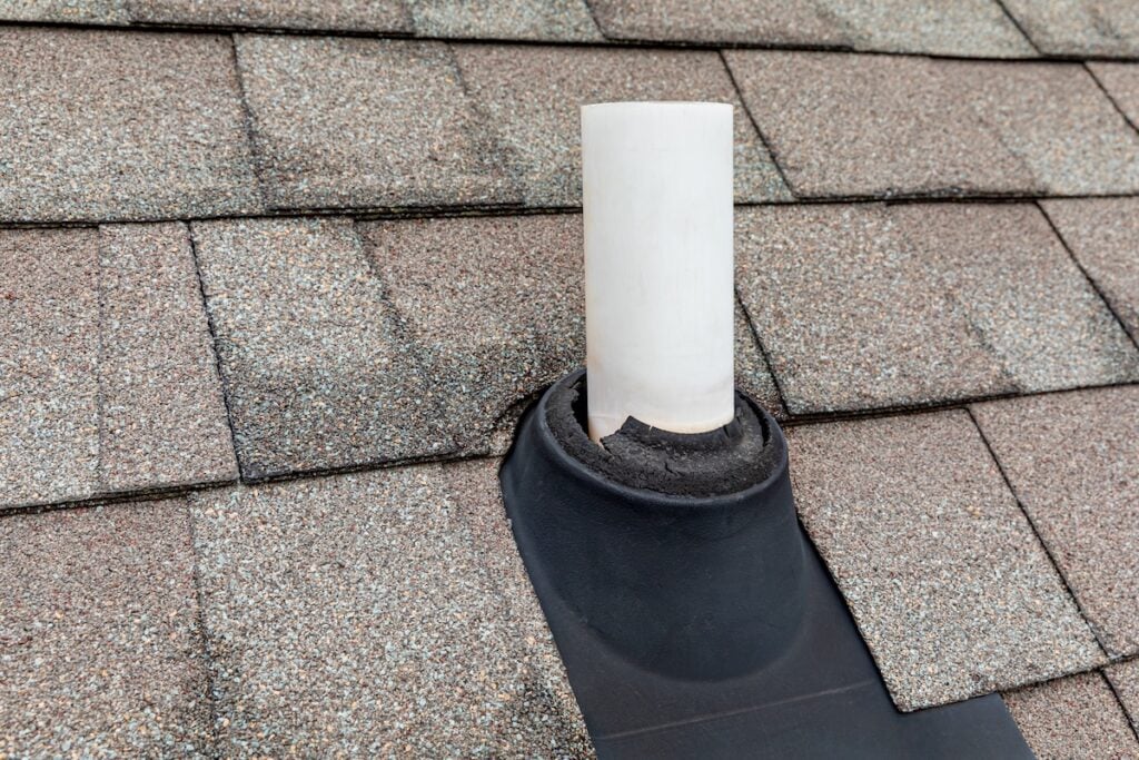 vent pipe flashing Old vent pipe flashing boot on roof of house. Roofing repair, home maintenance, and home inspection concept