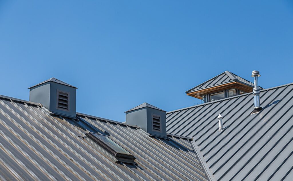 minimum slope for a metal roof Ribbed Metal Roof and Cupolas Under Blue Skies