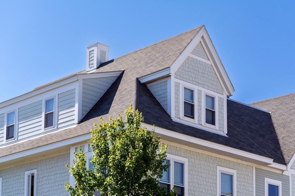 owens corning shingles Dormer windows on the sloped shingle roof of a newly built house