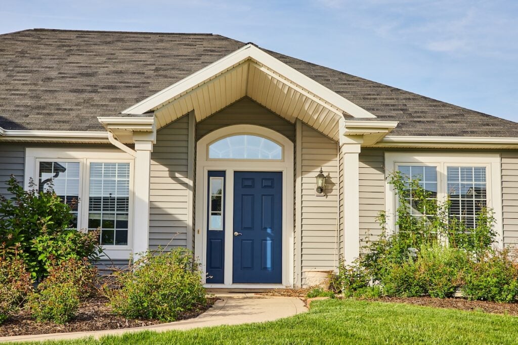 how to finance a new roof Image of Gray siding house blue front door, arch entryway, slate gray checkered roof landscaping asset