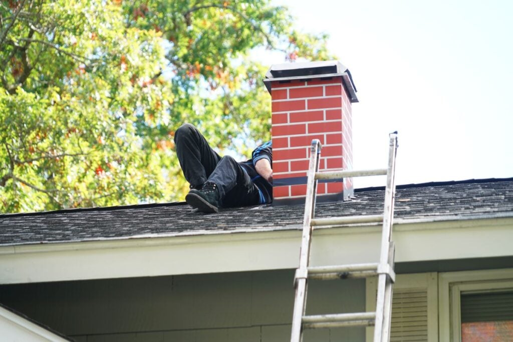 chimney cap man installing 