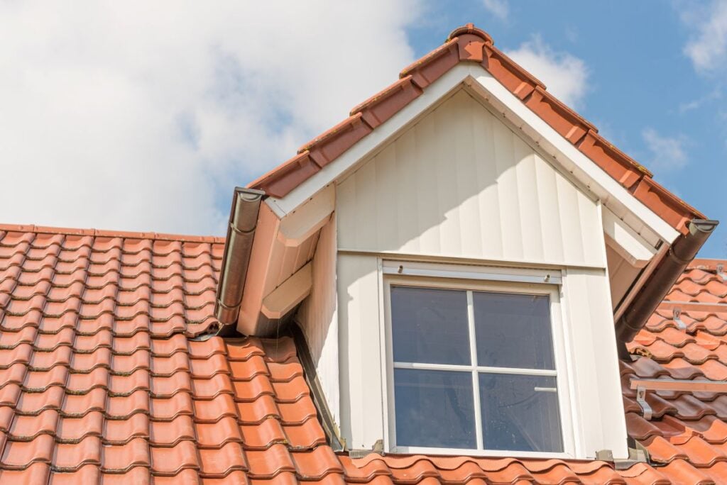 dormer roof hip style orange tiles white wall square window