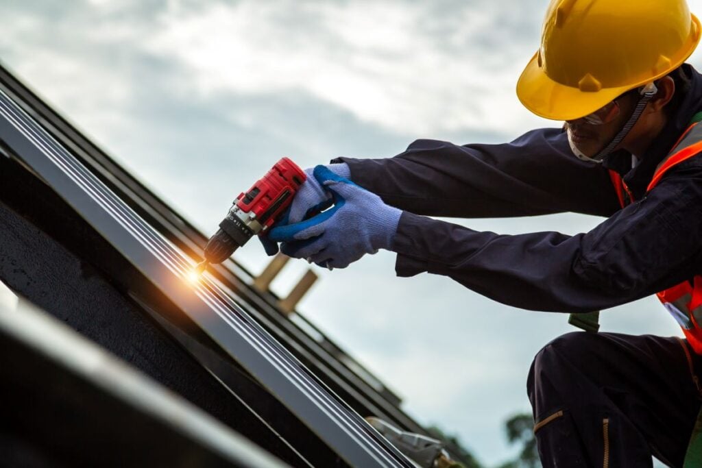 expert reliable roofers nail gun worker using protection