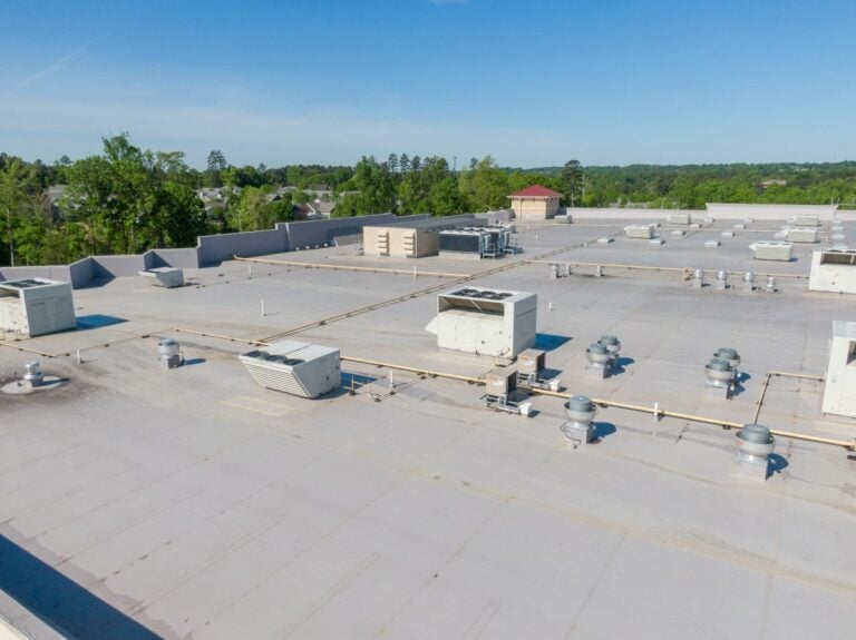 fm global requirements white commercial roofing blue sky