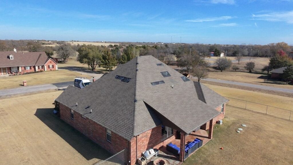 Aerial view of a house that is missing some shingles