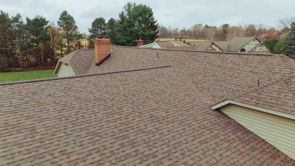 What Roofing Materials Increase Home Value in Edmond, Ok?  yellow sliding autumn season big family house