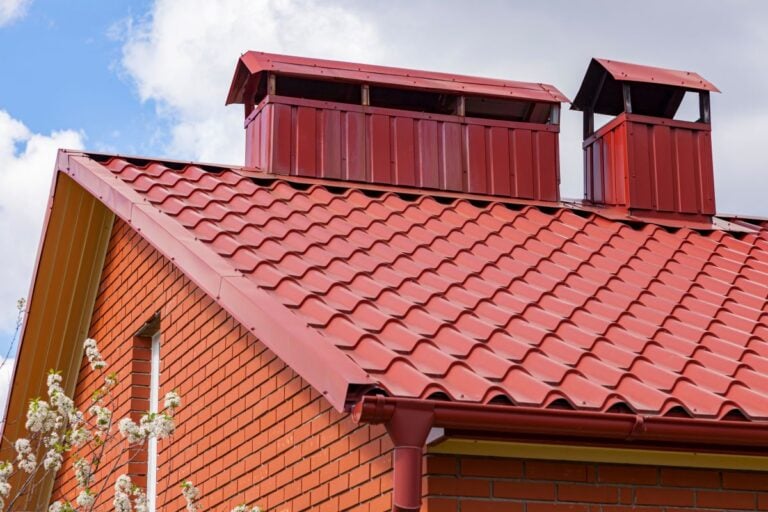 What Roofing Materials Increase Home Value in Edmond, Ok? red metallic tiles two chimneys