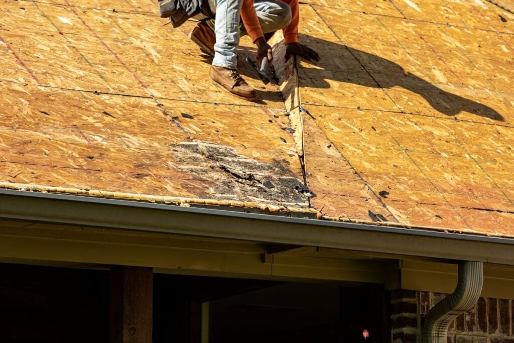 how much does a new shingle roof cost in norman ok worker repairing roof