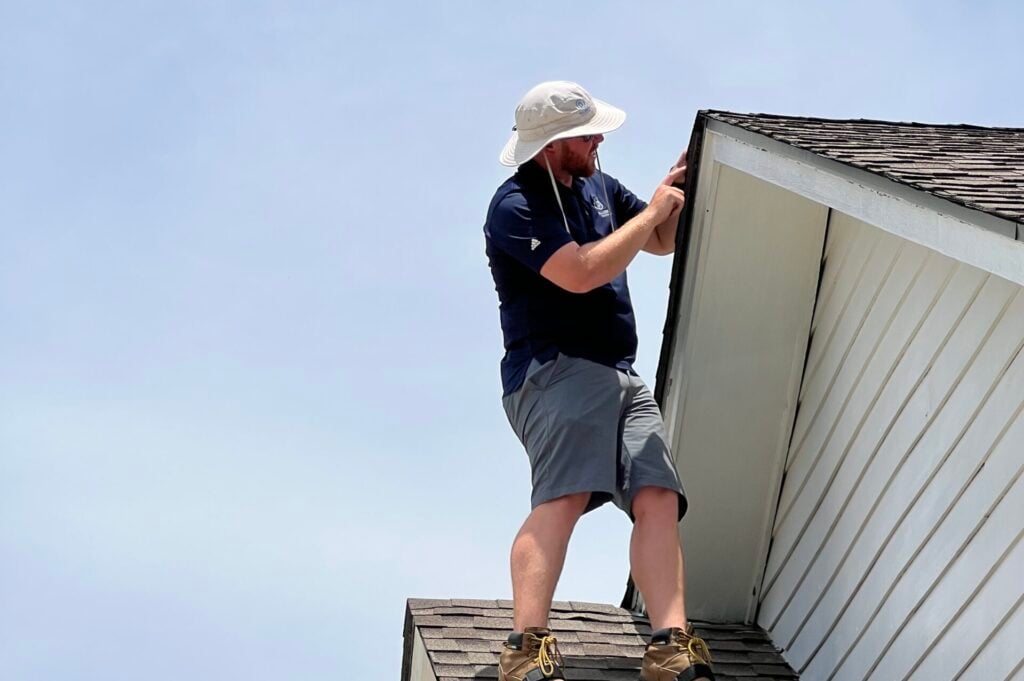 Palladium Roofing team member working on the roof