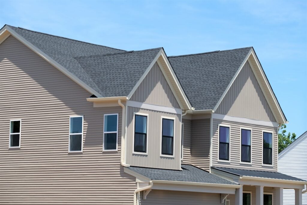 Beautiful new home exterior with on sunny day roof window modern front
